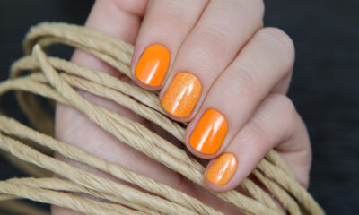 Nail art d'autunno arancione, con unghie completamente smaltate di un bel arancio intenso oppure alternate a nuance con glitter più chiari.
