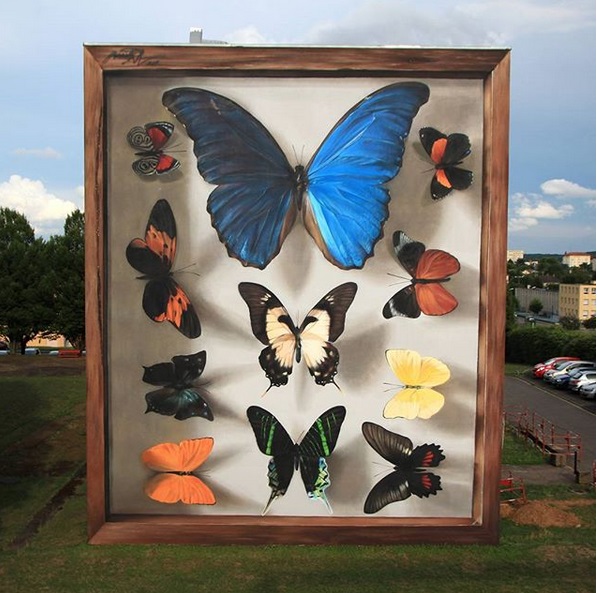 Street Art, l&#8217;artista che ravviva i quartieri con murales di farfalle giganti
